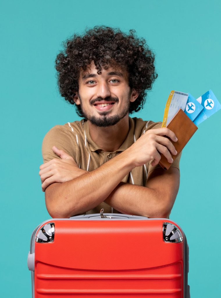 man-vacation-holding-tickets-leaning-his-red-bag-blue